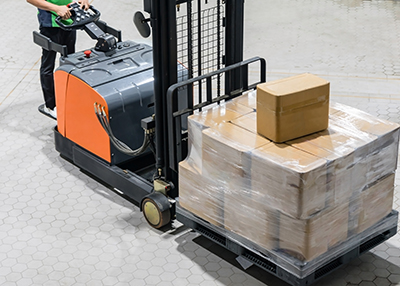 Electrical Forklift truck with boxes on pallet in warehouse