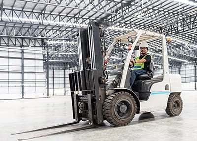 Trainee correctly parking counterbalance forklift truck